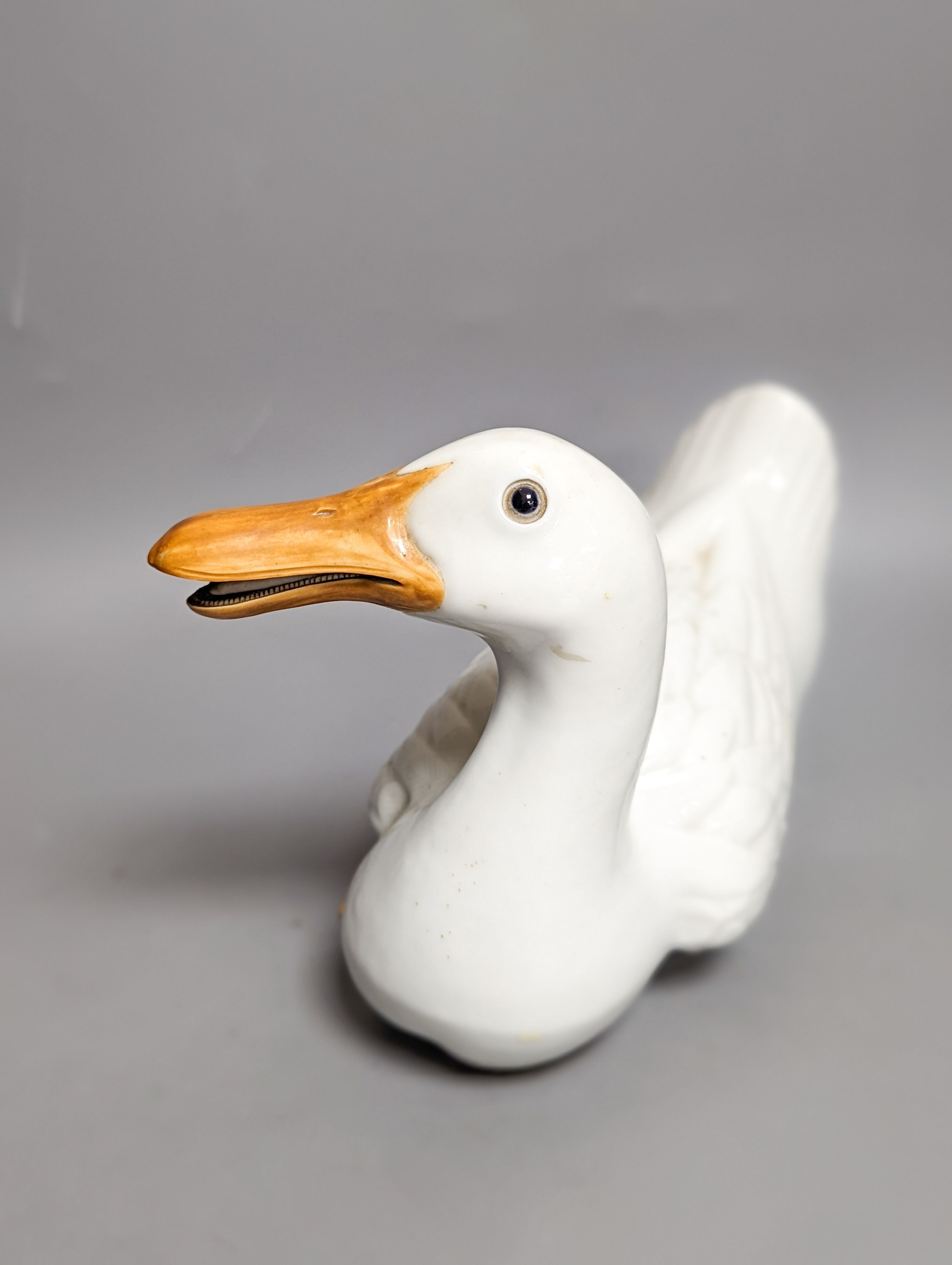 A modern painted decoy duck and a 20th century Chinese ceramic model duck (2) 42cm